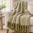 Tweedie green brushed herringbone throw styled on an oatmeal armchair