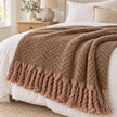 Tweedie mocha brushed herringbone throw layered across white linen bedding