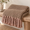 Tweedie mocha brushed herringbone throw folded on a pale oak bench