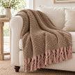Tweedie mocha brushed herringbone throw draped over a cream sofa
