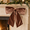 Widdop & Co velvet chocolate brown Christmas bow displayed on a mantelpiece