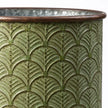 Close-up of the brown rolled rim and embossed leaf pattern on a vintage green metal planter