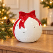 Satchville white Christmas bauble with red bow ornament