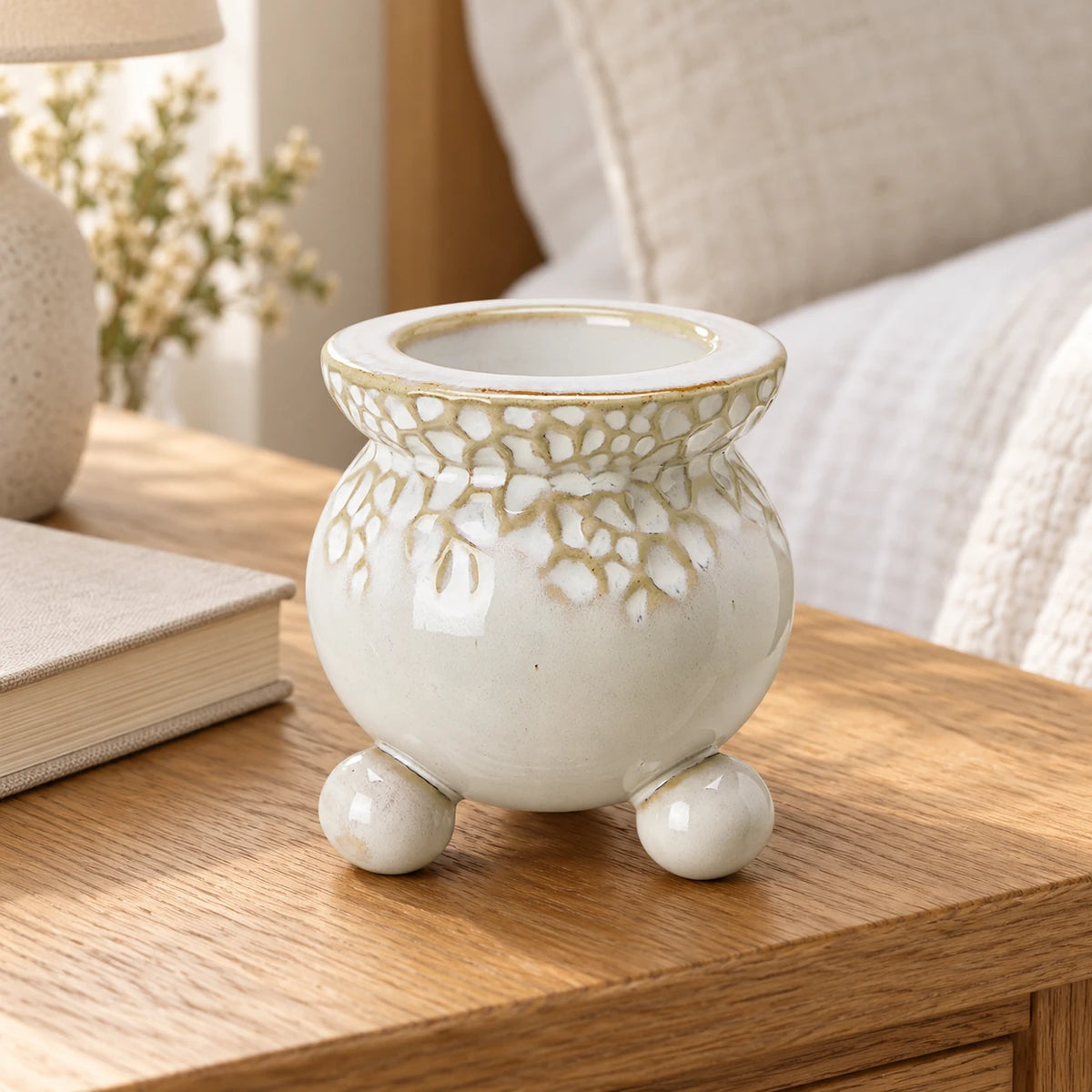 White Bobble Candle Holder — Empty holder on oak bedside table next to closed oatmeal book