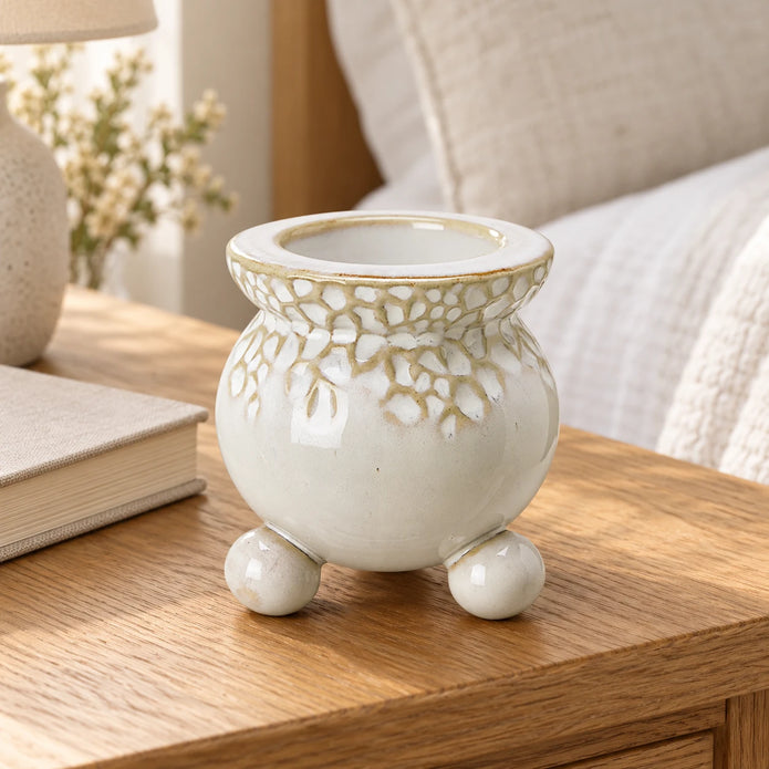 White Bobble Candle Holder — Empty holder on oak bedside table next to closed oatmeal book