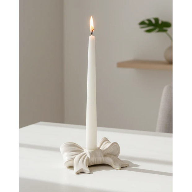 White ceramic dinner candle holder with a bow design, ideal for elegant home decor by Satchville.