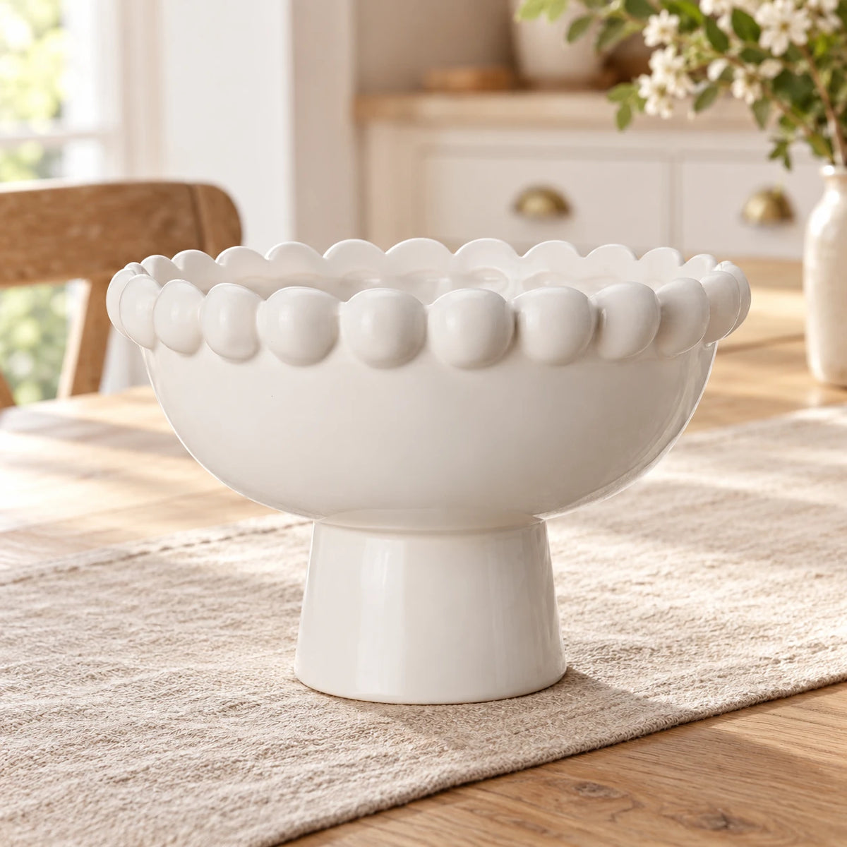 White Ceramic Bobble Footed Bowl — Empty bowl on pale oak dining table and oatmeal linen runner
