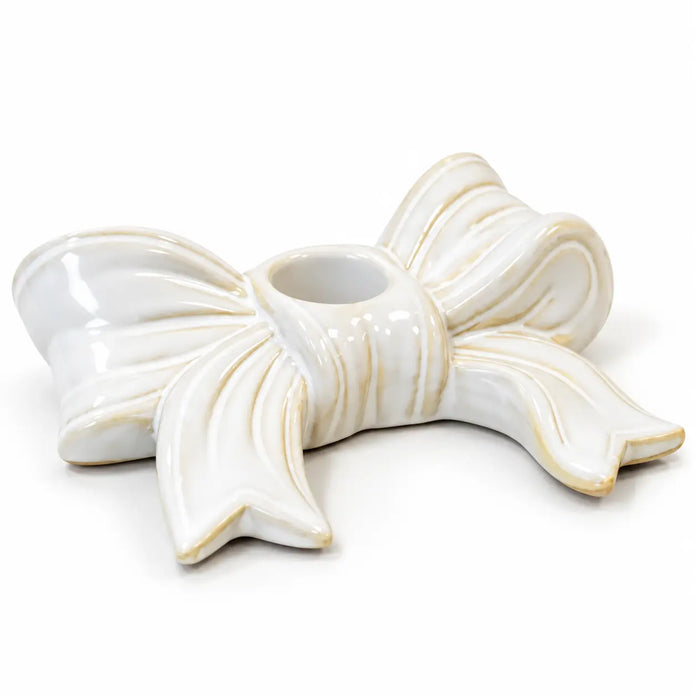 Empty white ceramic bow dinner candle holder on a clean white background