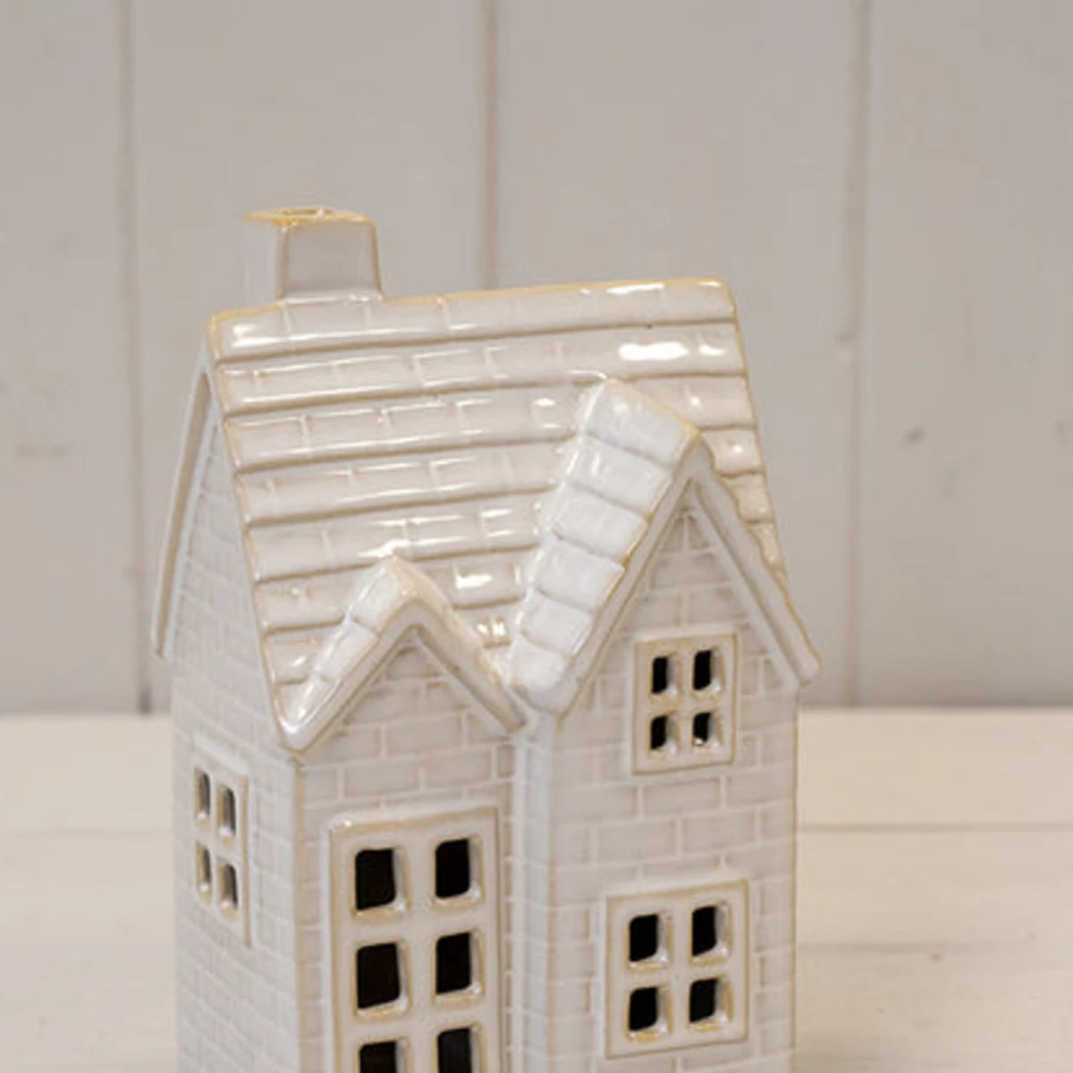 Close-up of glossy ceramic tiled roof, chimney and window details on the medium LED Christmas house