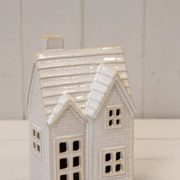 Close-up of glossy ceramic tiled roof, chimney and window details on the medium LED Christmas house