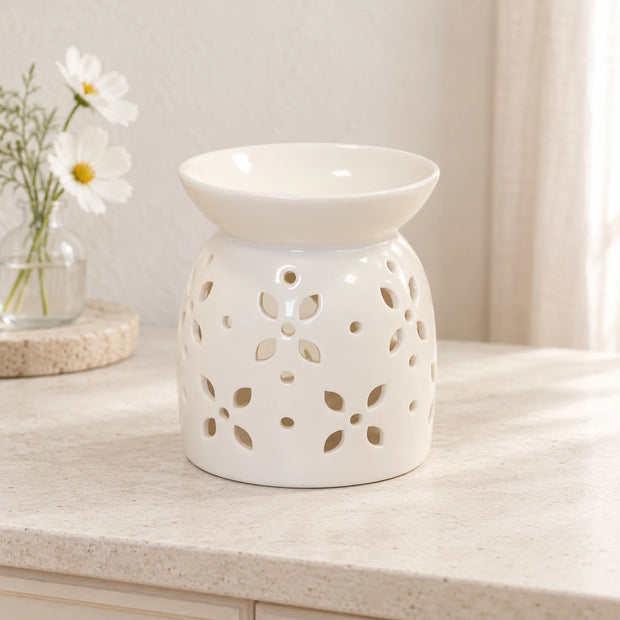 White ceramic wax melt burner with a flower petal design, featuring a glazed finish from Satchville.