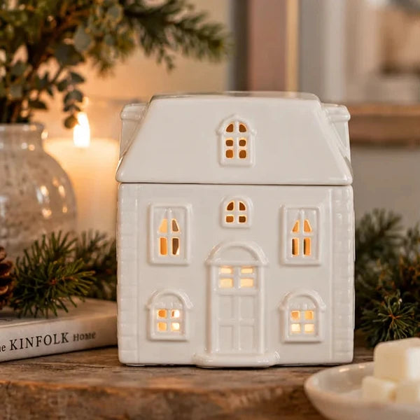 White ceramic house-shaped wax melt oil burner for Christmas decor, featuring a cozy festive design.