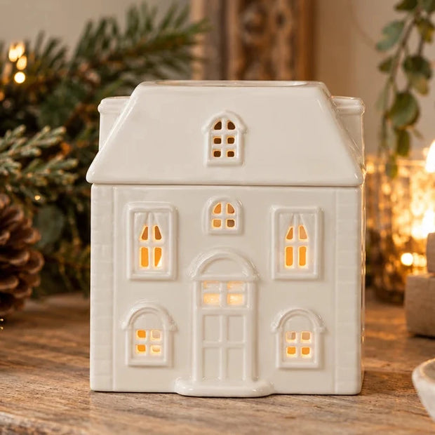 White ceramic house-shaped wax melt oil burner with Christmas-themed design, perfect for holiday aromatherapy.
