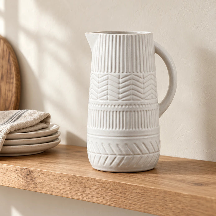 27cm white patterned ceramic jug displayed empty on an oak kitchen shelf.