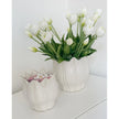 White ceramic Leslie Tulip Pot by Wikholmform, perfect for spring floral arrangements, showcasing a smooth, elegant tulip-shaped design.