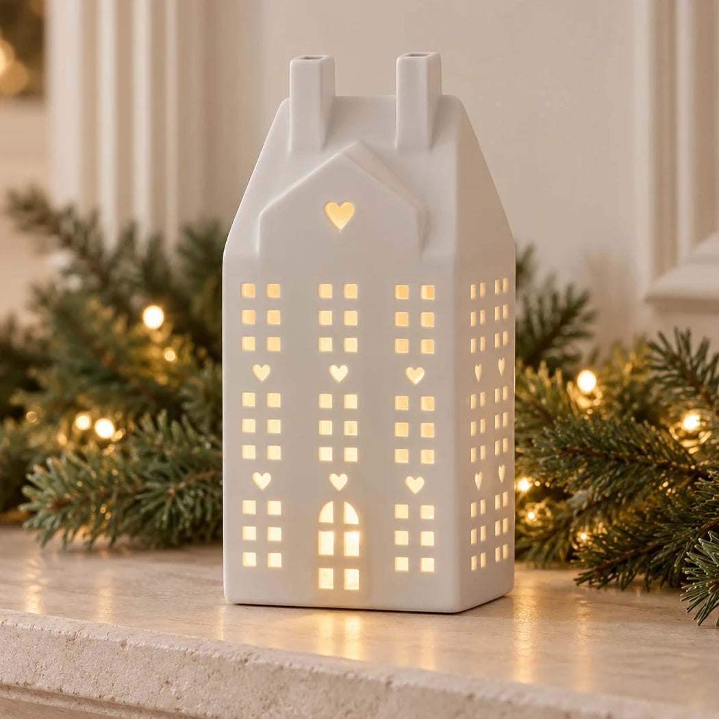 White ceramic matte LED Christmas house figurine by Sifcon, illuminated with warm LED lights, perfect for holiday mantel decor.