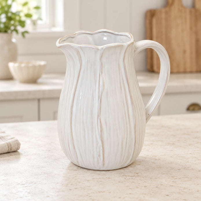 Large white ceramic petal jug on a light stone kitchen worktop