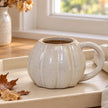 White ceramic pumpkin mug with autumn design on a breakfast tray, perfect for seasonal cozy mornings by Satchville.