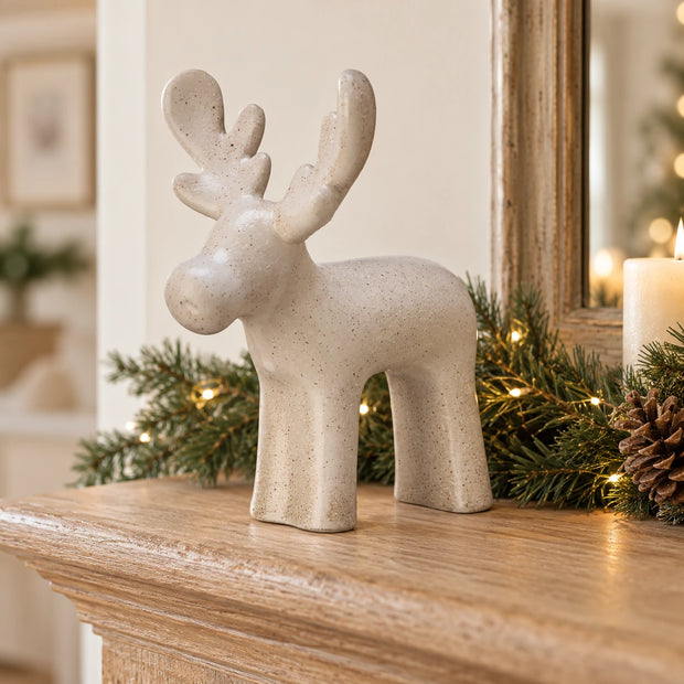 White Ceramic Reindeer — One reindeer on pale oak mantel