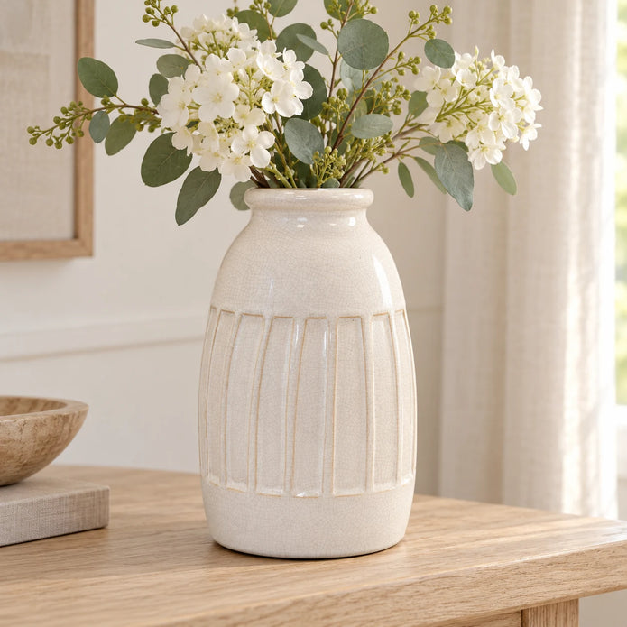 Medium white ceramic vase with ribbed design by Satchville, showcasing its smooth, elegant surface and rounded shape.