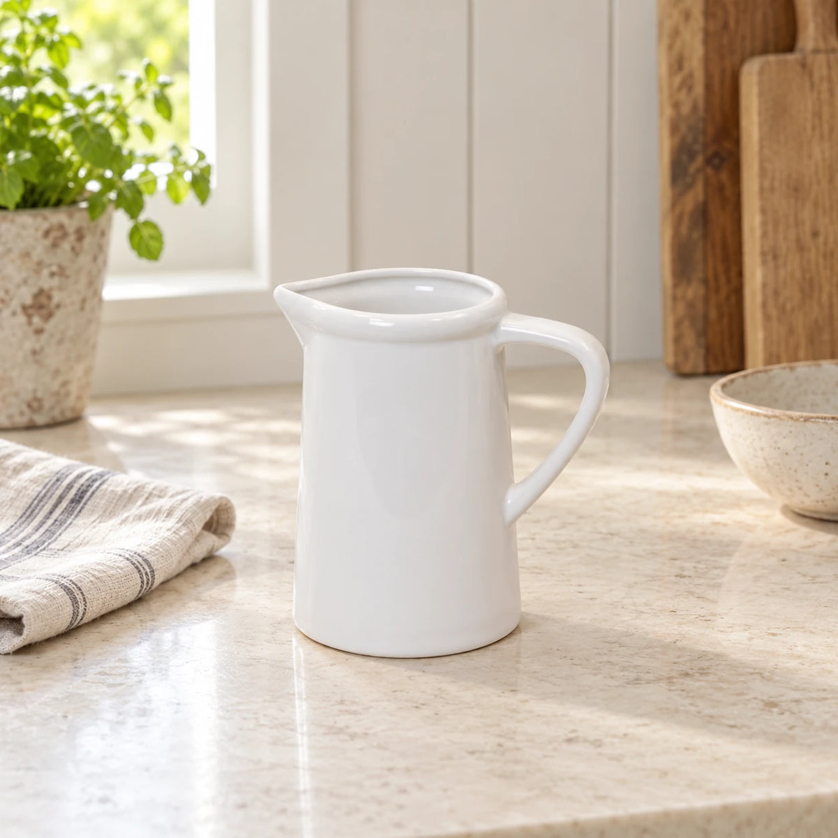 White ceramic small flower jug vase by Satchville, showcasing a smooth finish and compact design for floral arrangements.