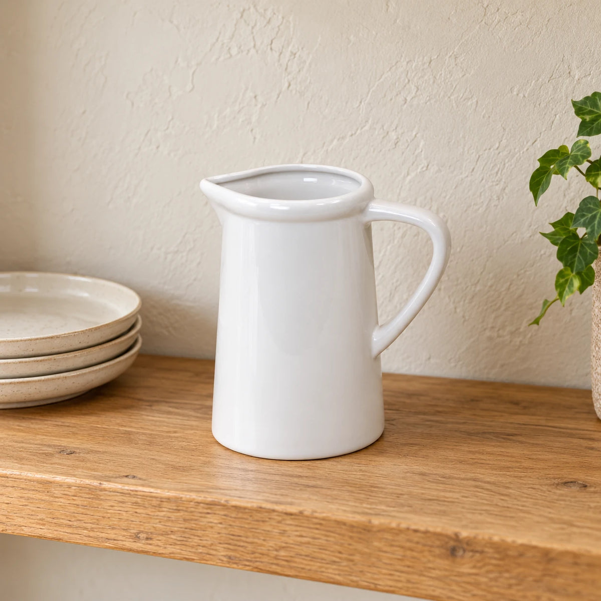 White ceramic small flower jug vase by Satchville, featuring a smooth finish and compact design, perfect for floral arrangements.