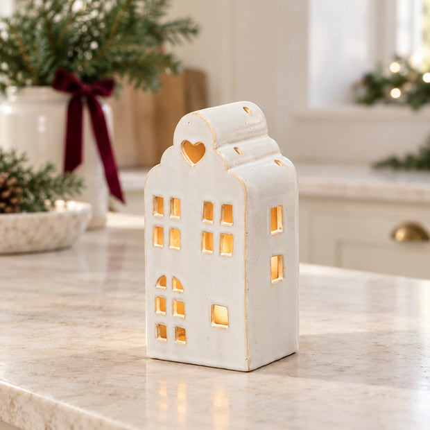 White ceramic townhouse tealight candle holder from Satchville, designed for Christmas decorations, featuring a detailed house design.