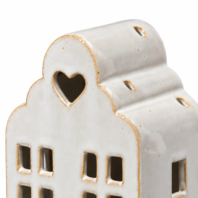 Close-up of the white ceramic house heart opening, stepped roof and glazed edges