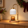 White candle warmer lamp styled on an oak sideboard for Christmas