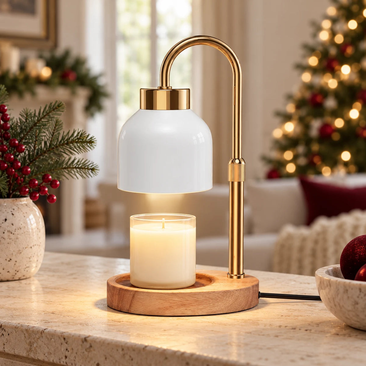 White enamel-effect candle warmer lamp with gold arm and wooden base on a Christmas console
