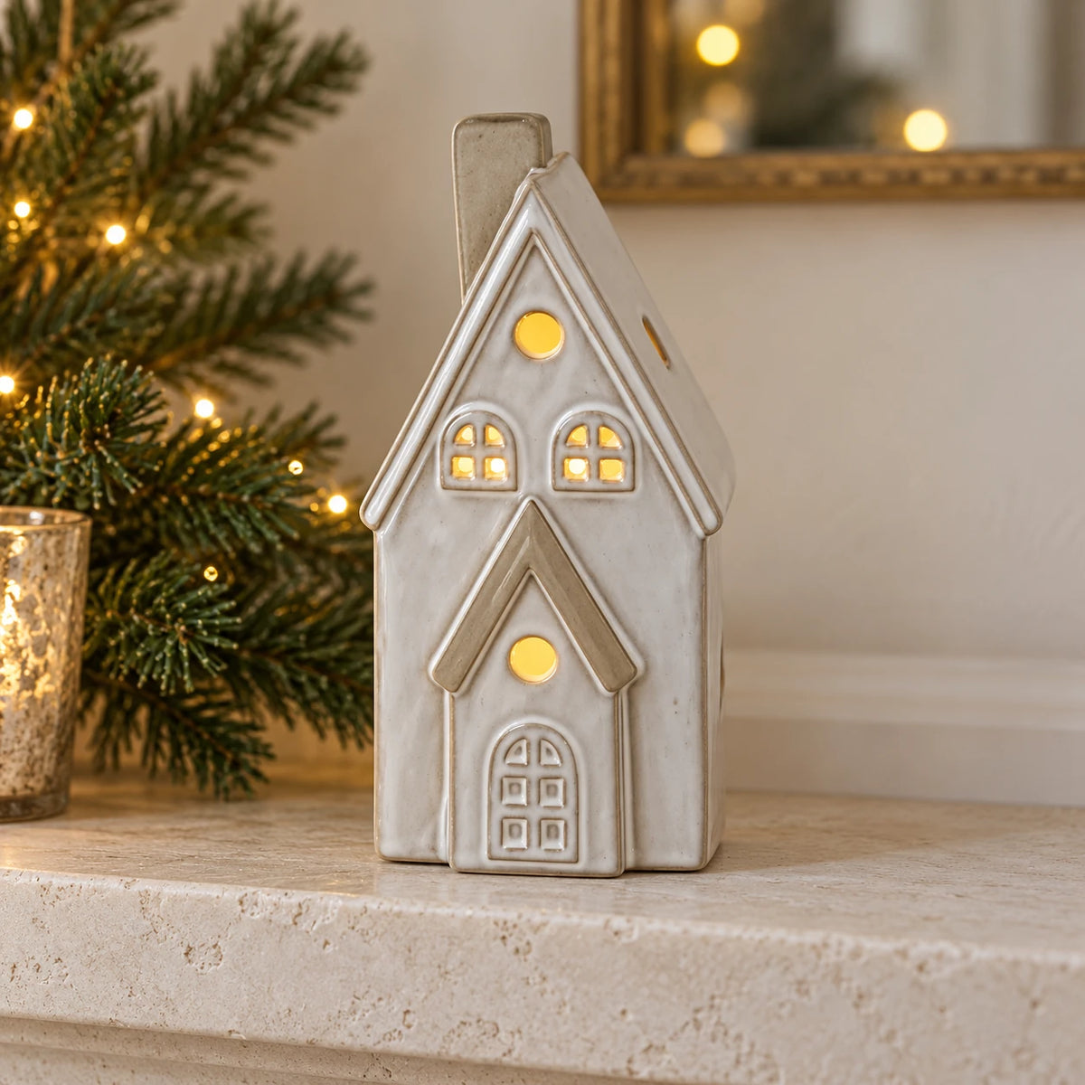 Satchville white glazed ceramic LED house Christmas decoration for a mantelpiece