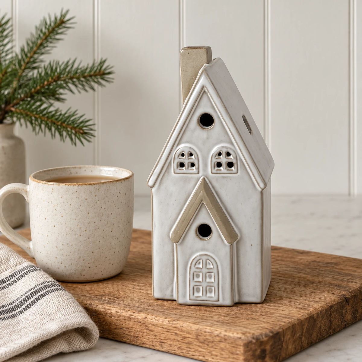 Satchville white glazed ceramic Christmas house with light-up LED windows, 17cm tall