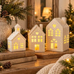 White heart LED ceramic village houses on a rustic Christmas mantel