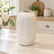 Large warm white ceramic leaf vase, 29cm tall, styled empty in a bright neutral kitchen.