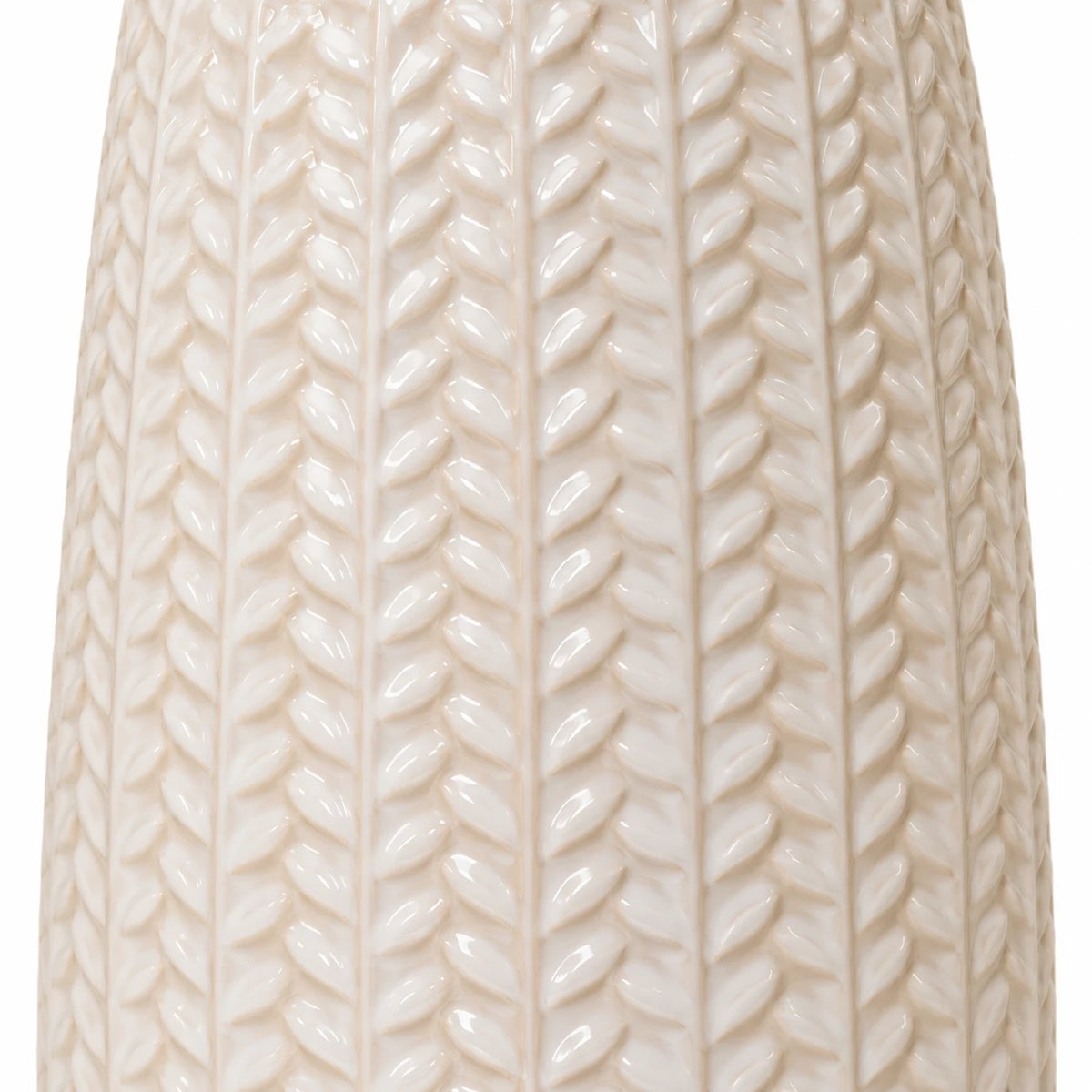 Close-up of the glossy white leaf relief pattern on the ceramic vase