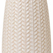 Close-up of the glossy white leaf relief pattern on the ceramic vase
