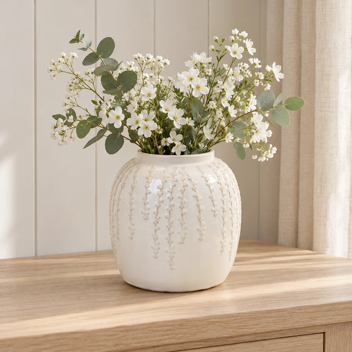 Small warm white ceramic leaf vase, 18cm tall, styled with white flowers and eucalyptus on a pale oak console.
