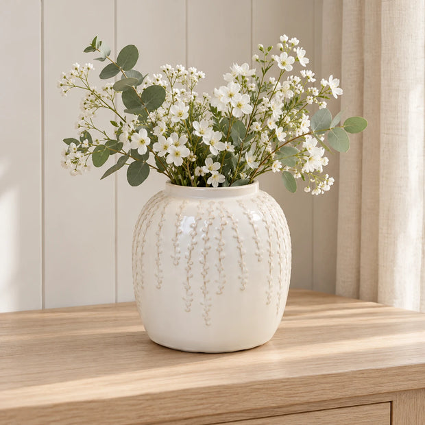 Small warm white ceramic leaf vase, 18cm tall, styled with white flowers and eucalyptus on a pale oak console.