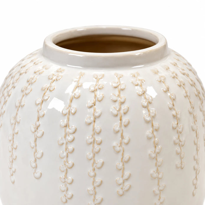 Small warm white ceramic leaf vase, 18cm tall, close-up of the glazed trailing leaf detail on white.