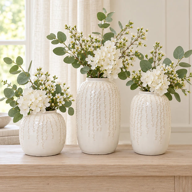 Three warm white ceramic leaf vases shown together for size comparison: small 18cm, large 29cm and medium 24cm; sold separately.