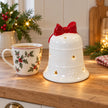 Satchville white Christmas light-up LED bell with red bow on kitchen scale