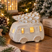 White ceramic LED light-up Christmas camper van with sculpted snowy tree on the roof, styled with festive greenery