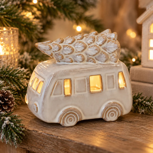 White LED Christmas camper van with a Christmas tree on the roof, designed by Satchville, illuminated for festive holiday decor.