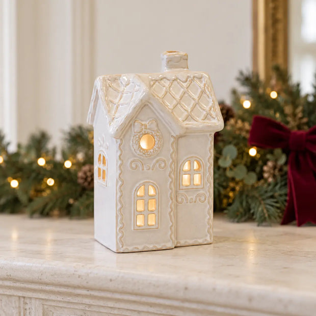 White LED Christmas townhouse decor by Satchville, illuminated festive holiday display with detailed town scene on mantel.