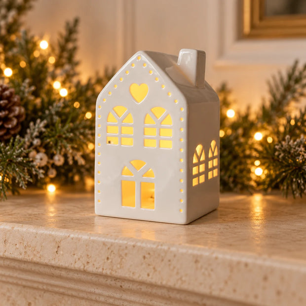 White large light-up LED Christmas house with heart by Gainsborough Giftware x Portland Living on mantelpiece