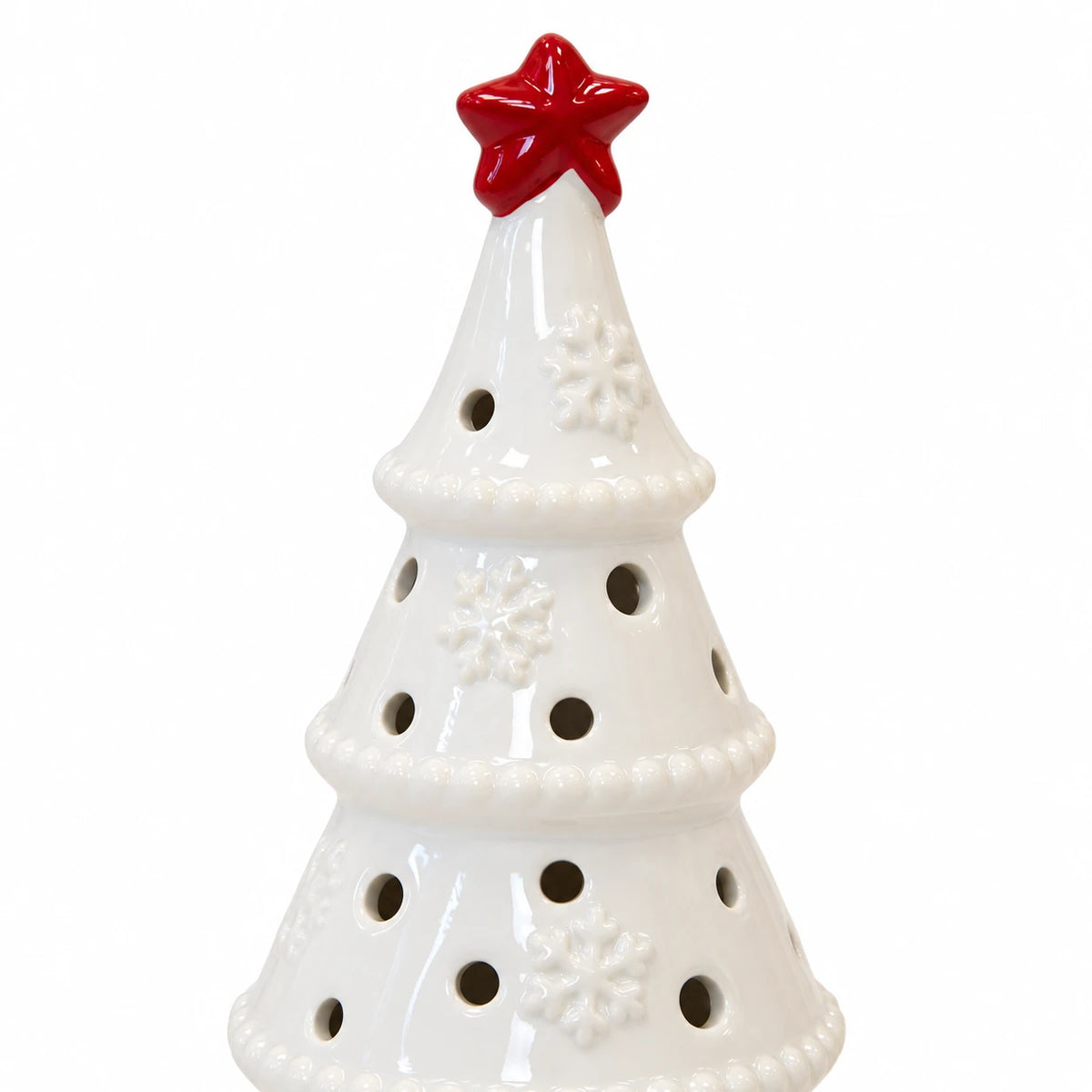 Close-up of the red star, raised snowflakes and circular openings on the white ceramic tree, LED off.