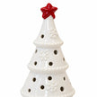 Close-up of the red star, raised snowflakes and circular openings on the white ceramic tree, LED off.