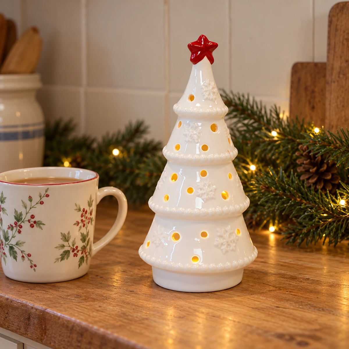 Twenty-centimetre white LED tree with red star beside a mug of tea for scale.
