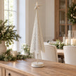 Extra large white and gold metal Christmas tree on a country-house sideboard.