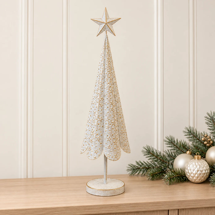Large white metal Christmas tree with gold stars on a pale oak console with festive greenery